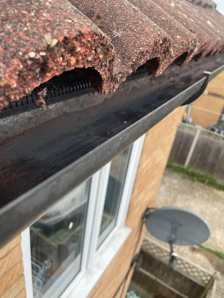 A cleared gutter run, the channel clean and the downpipe flowing